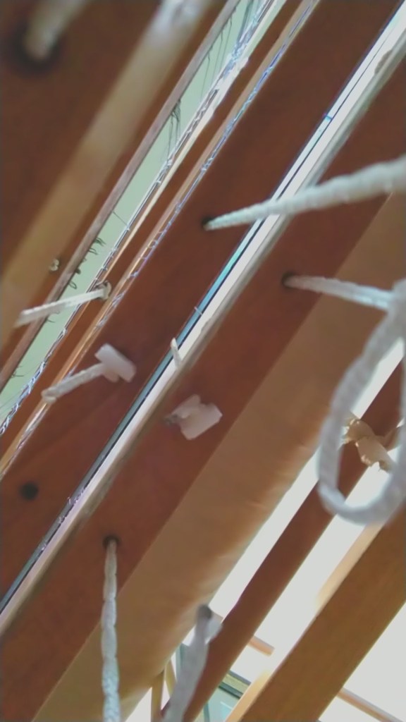 Lamms on a floor loom viewed from below showing the texsolv cords connecting to the treadles.